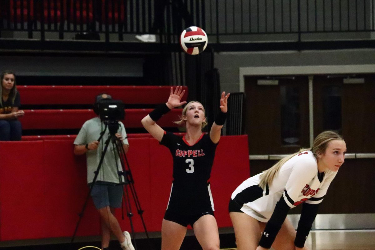 Coppell senior libero Kate McDonald serves against Flower Mound on Tuesday at CHS Arena. The Cowgirls lost,  25-17, 25-13, 25-12, to Jaguars in District 6-6A action.