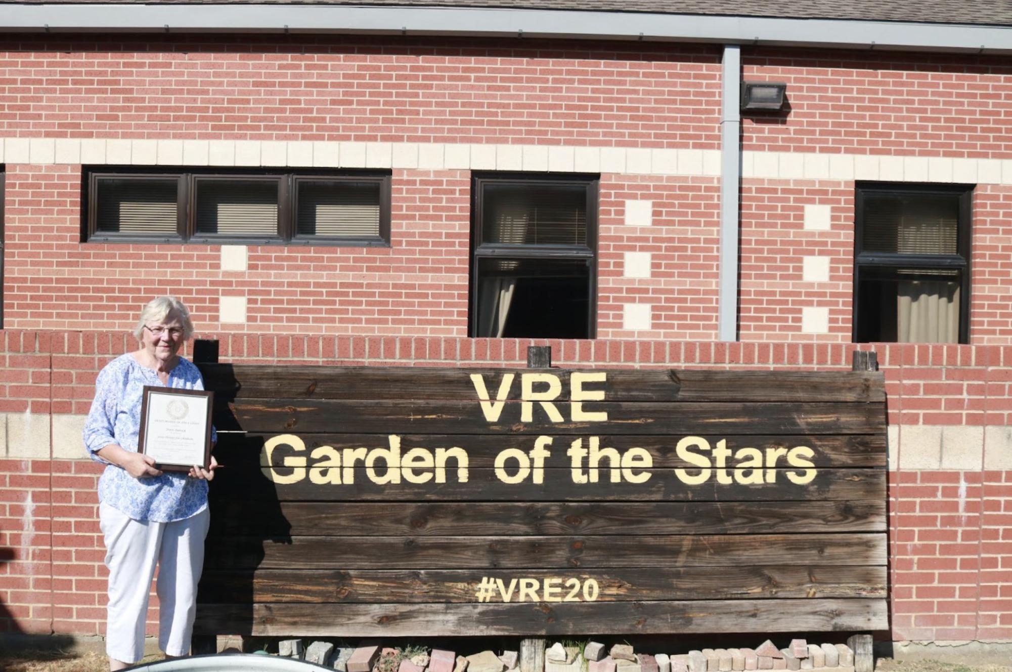 Valley Ranch Elementary School garden volunteer Doris Patrick holds her prestigious Heroes for Children Award in the VRE Garden of the Stars. The Heroes for Children Award is given to residents who commit time and support toward public schools, in which Patrick was one of 15 in Texas to receive the award.
