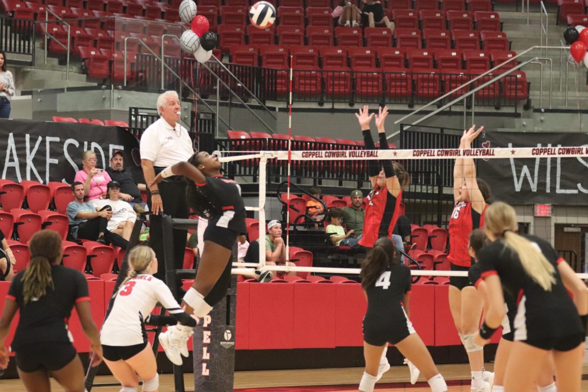 Coppell senior outside hitter Daki Kahungu spikes against Flower Mound Marcus at CHS Arena on Friday. The Cowgirls defeated the Marauders, 22-25, 25-17, 25-18, 18-25, 15-13.