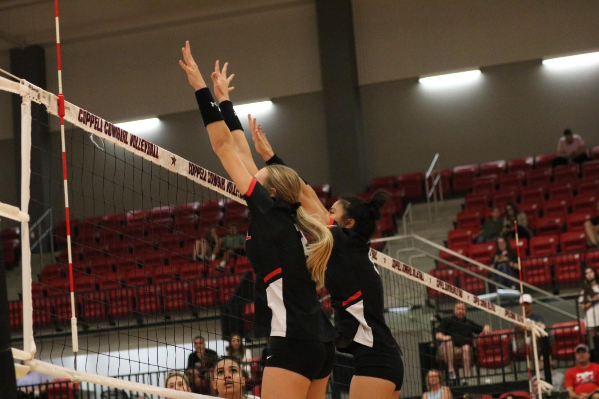 Coppell senior opposite hitter Mira Klem and senior middle blocker Alena Troung block against Royse City at CHS Arena on Aug 22. The Coppell volleyball team plays Plano West tomorrow at 6:30 p.m. in the first district match.