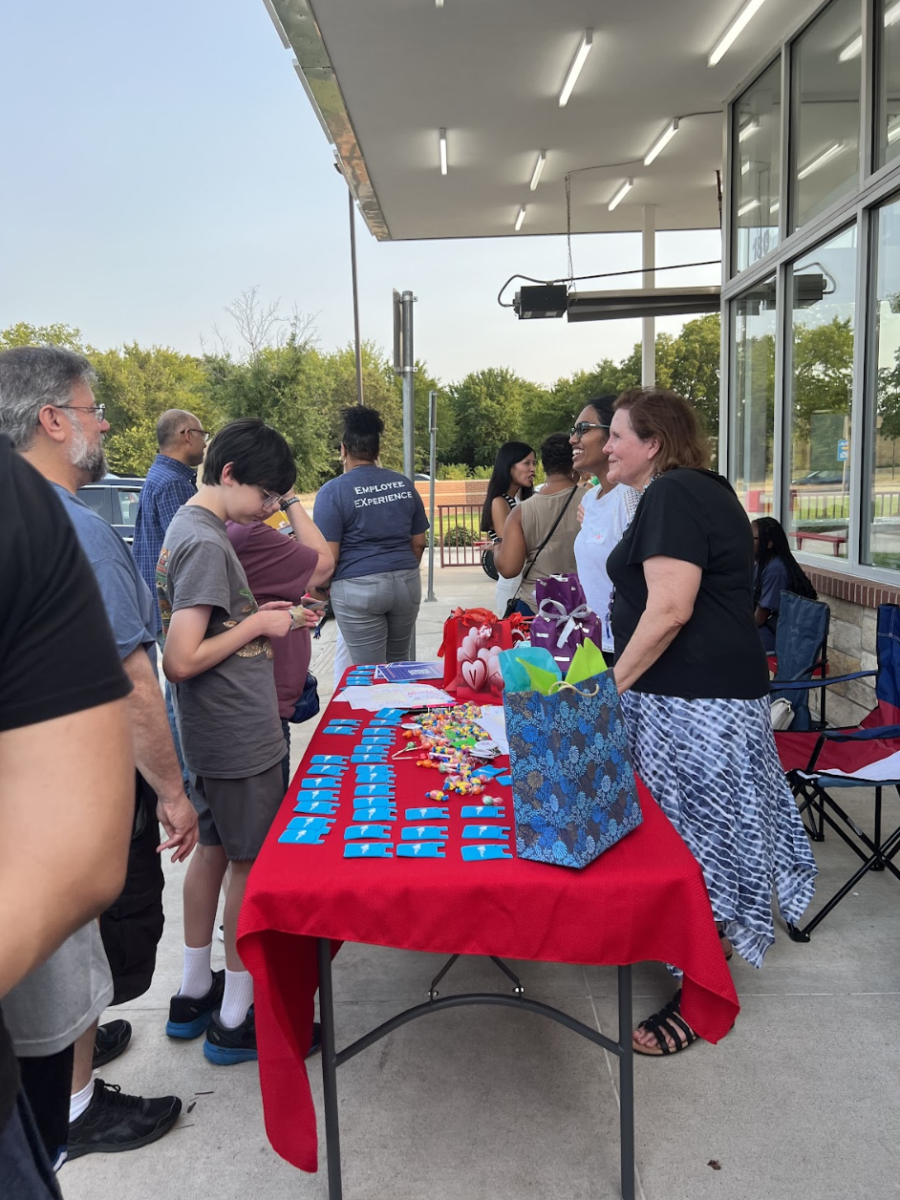 Event support organizers Tasnim Benhalim and Vidya Venkat promote Allies In Community while distributing buttons and cardholders on Aug. 18 at Andy’s Frozen Custard. AIC is an organization committed to making people of different backgrounds feel welcome and accepted in their community. 