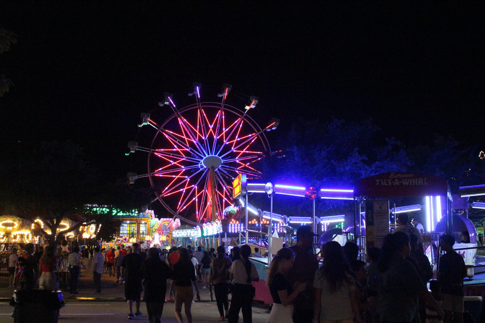 Fluorescent lights decorate the ferris wheel and other attractions at the St. Ann Catholic Parish Community Carnival. The 30th annual St. Ann’s carnival took place Sept. 8-10 in the parking lot of the church and provided entertainment, games, rides and food to attendees. 