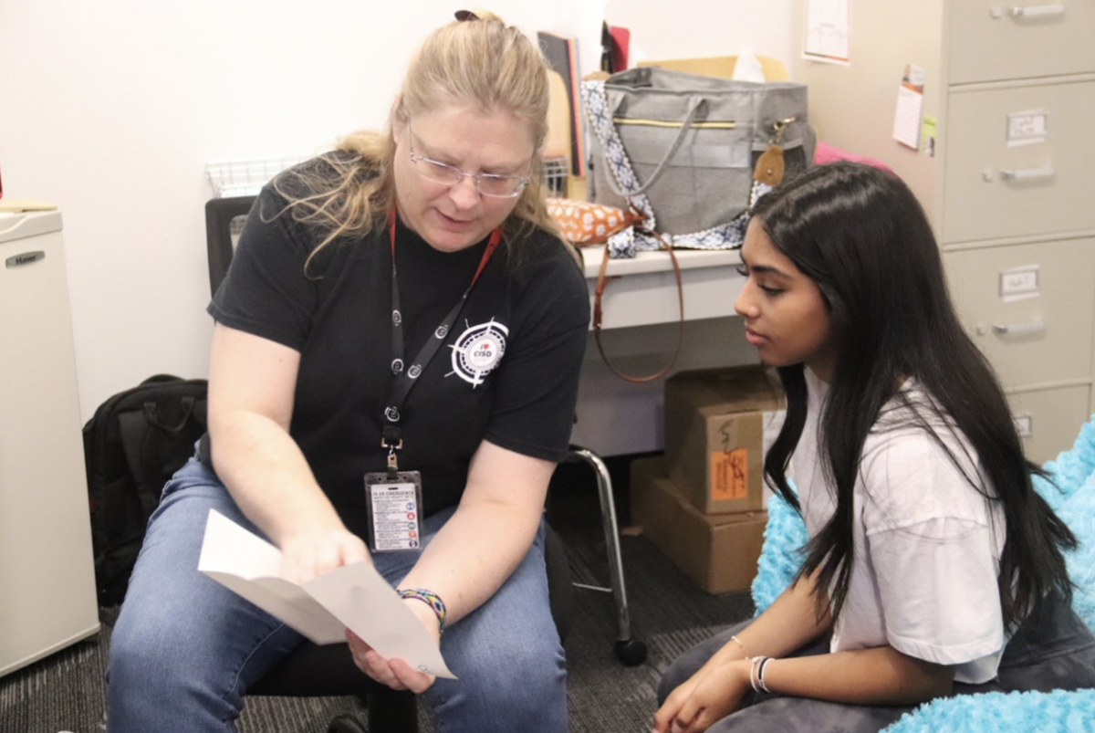 Coppell High School Round-Up yearbook adviser Katrina Hester explains the senior page layout to senior managing editor Samita Alagashetty. Hester previously taught English for the past three years at Plano West High School, and the 2023-24 school year is her first year advising yearbook at CHS.
