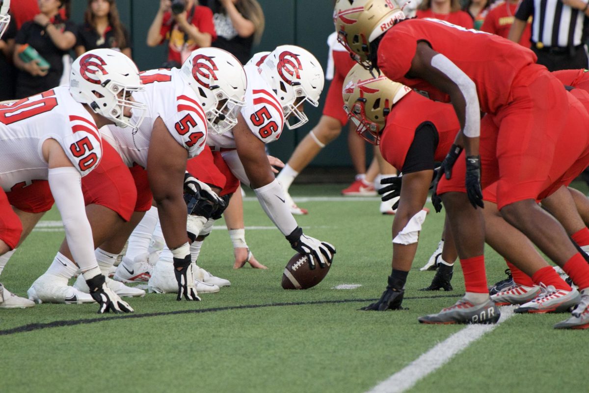 Coppell senior center Alex Jackson prepares to start the play at the line of scrimmage with offensive lineman juniors Jordan Stafford and Jacob Reyes against South Grand Prairie at Gopher-Warrior Bowl on Friday. Coppell defeated the Warriors, 44-34.