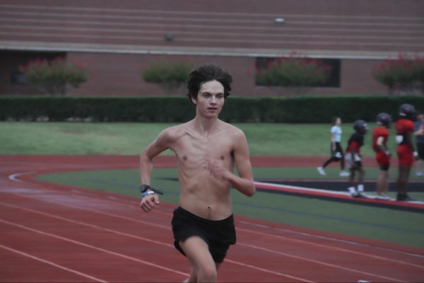 Coppell senior cross country runner Henry Henze sprints at Buddy Echols Field during morning practice on Thursday. Cross country girls had their best performance this season at Northwest Invite on Saturday.
