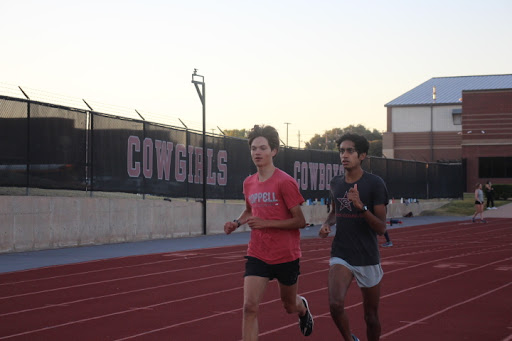 Coppell High School seniors Henry Henze and Samarth Dubey run during cross country morning practice at Buddy Echols Field. The CHS cross country team competes weekly in meets around Texas, having done three meets so far during the 2023-24 season. 