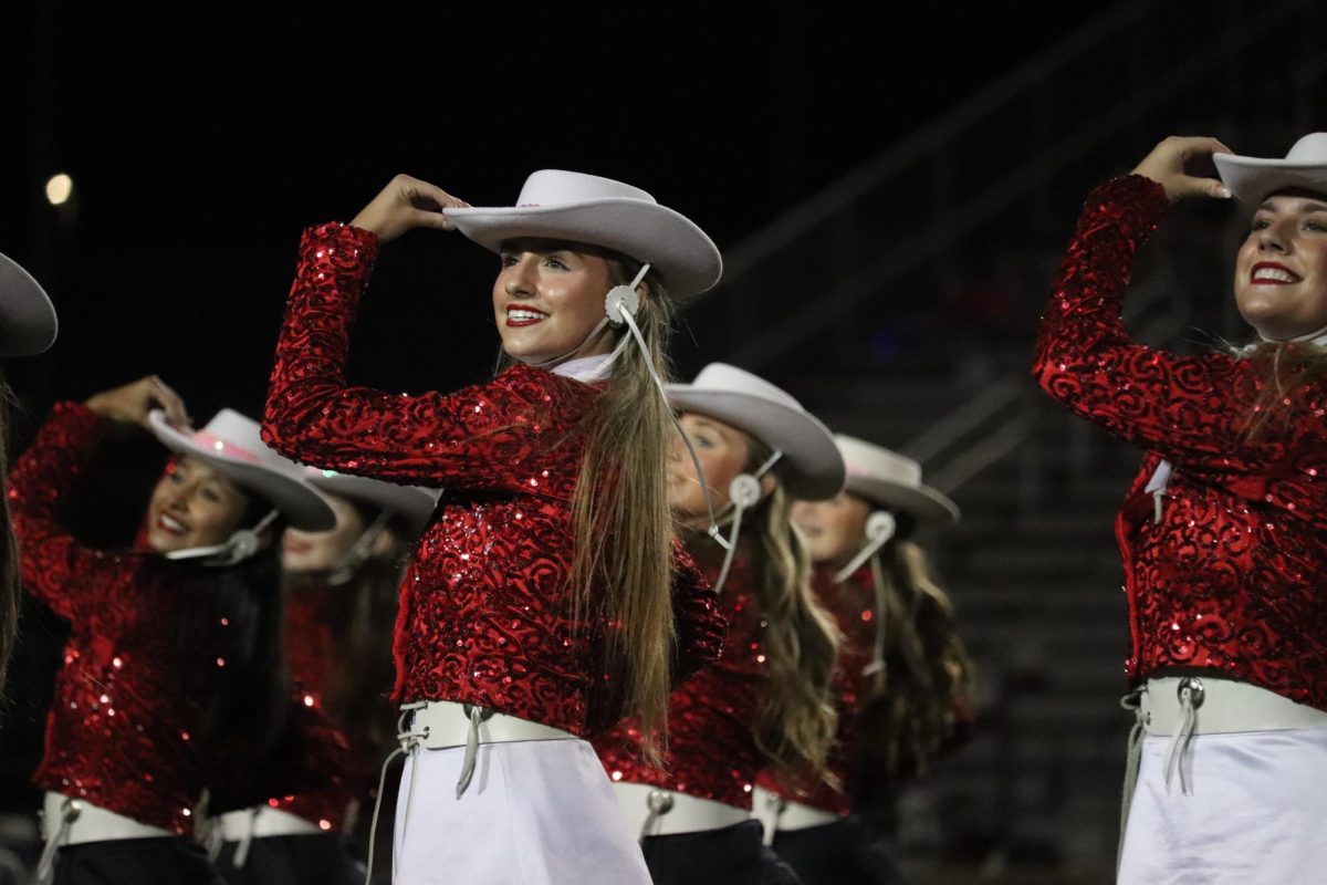 Coppell junior Lariettes lieutenant Emme Ratliff performs the iconic kick line dance during halftime at the Cowboys game against Hebron at Hawk Stadium on Oct. 20. Ratliff is one of six Lariette officers and has been an avid dancer for the past 14 years. 