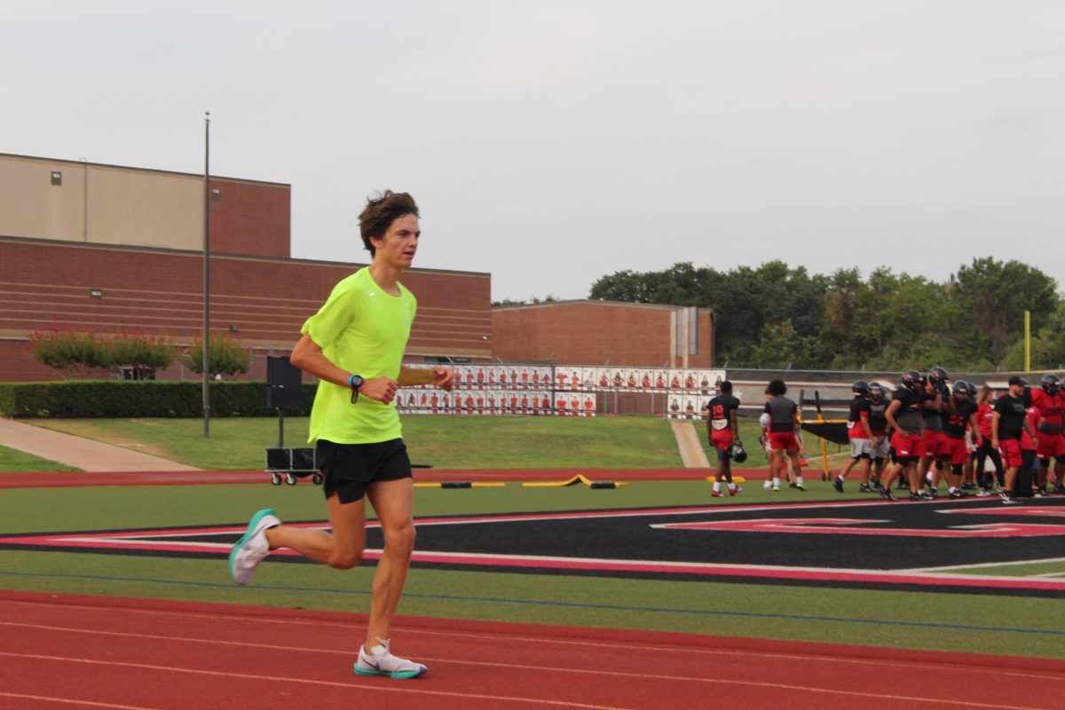 Coppell senior cross country runner Henry Henze sprints at Buddy Echols Field during morning practice on Sept. 12. Henze has stepped into a new role of leadership in the cross country team for the 2023-24 school year. 