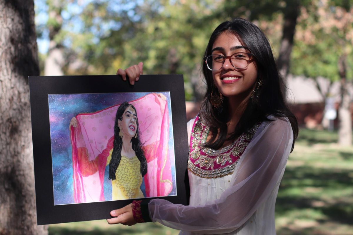 Coppell High School senior Isha Rahi holds her piece titled “A Daughter’s Burden.” Rahi is president of National Arts Honors Society and uses art as a medium to advocate for South Asian women.