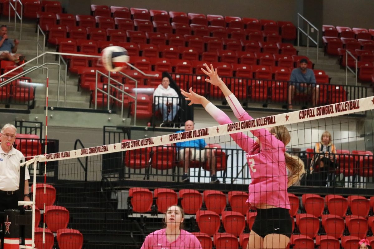 Coppell senior opposite hitter and volleyball co-captain Mira Klem jumps to block at the Oct. 17 game against Hebron. Klem stepped into a leadership role this season and implemented the same positive influence on her teammates as her predecessors.