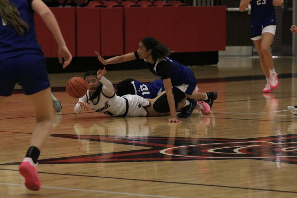 Coppell junior guard Madalena Nguyen drives for a loose ball against Byron Nelson on Nov. 7 at Coppell High School Arena. The Cowgirls defeated the Bobcats, 63 - 48.   
