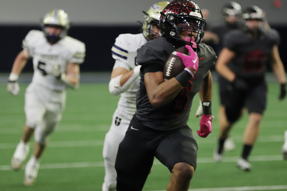 Coppell junior running back O’Marion Mbakwe rushes towards the end zone, sealing the game with a final touchdown against Dallas Jesuit on Thursday at Ford Center in Frisco. Coppell defeated Jesuit, 42-23, in the Division II Region I area playoffs, advancing to the Class 6A Division II Region I regionals on Saturday against Byron Nelson at Choctaw Stadium in Arlington. 