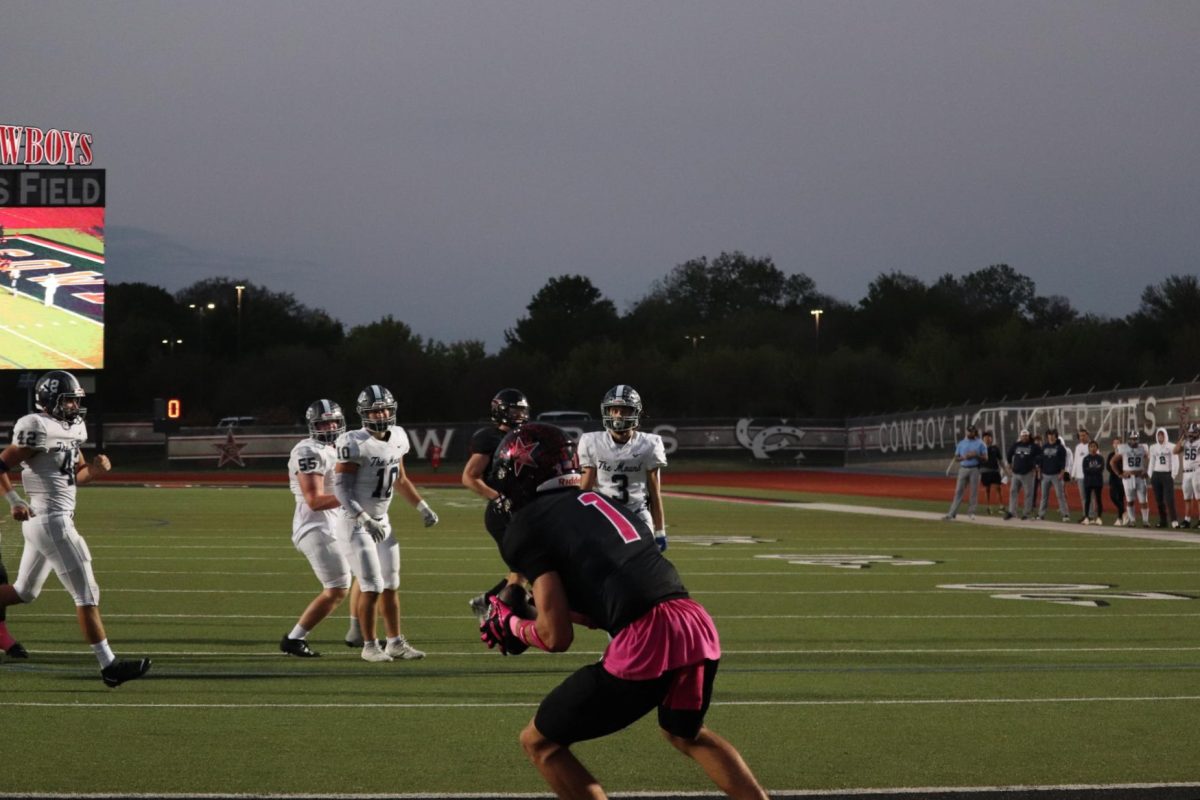 Coppell senior wide receiver Baron Tipton receives a touchdown pass from junior quarterback Edward Griffin in the second quarter against Flower Mound on Oct. 27. The Cowboys defeated the Jaguars, 51-21, at Buddy Echols Field.