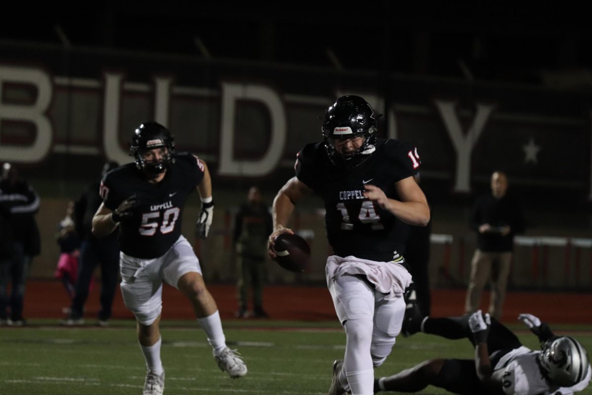 Coppell junior quarterback Edward Griffin scrambles for a first down during the first quarter against Denton Guyer at Buddy Echols Field on Friday. The Cowboys defeated the Wildcats, 35-21, to make it to the second round of playoffs. 