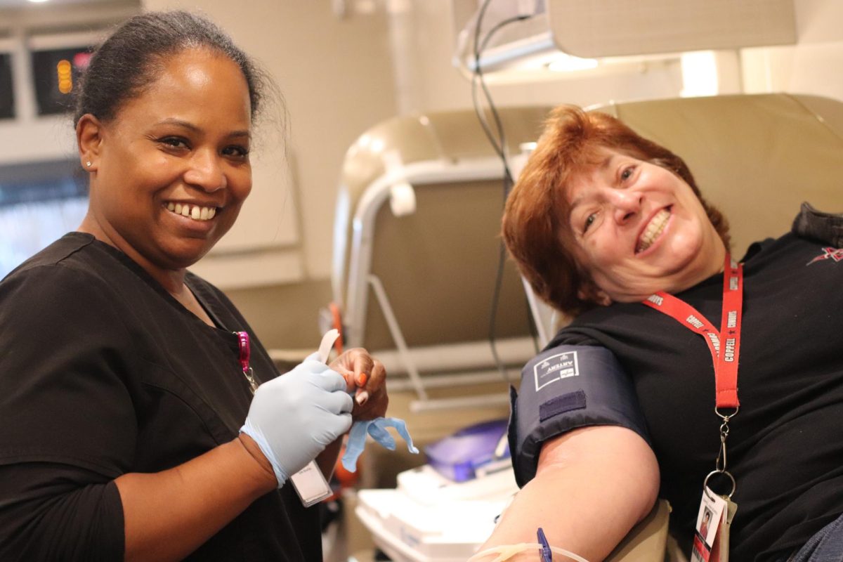 A Carter Blood Care worker takes Coppell High School counselor Cheryl Abreu’s blood for the Coppell HOSA blood drive. Coppell HOSA hosts its annual blood drive in collaboration with Carter BloodCare on Friday at the CHS student parking lot. 