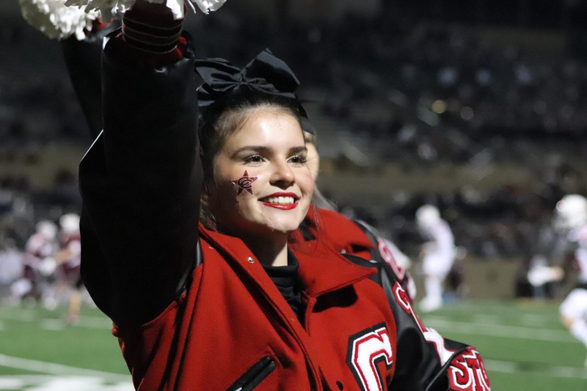 Coppell sophomore Avery Ayres cheers as the Coppell football team plays  Plano at Buddy Echols Field on Nov. 3. Ayres has been cheering competitively for 10 years and is on Coppell’s varsity cheer team