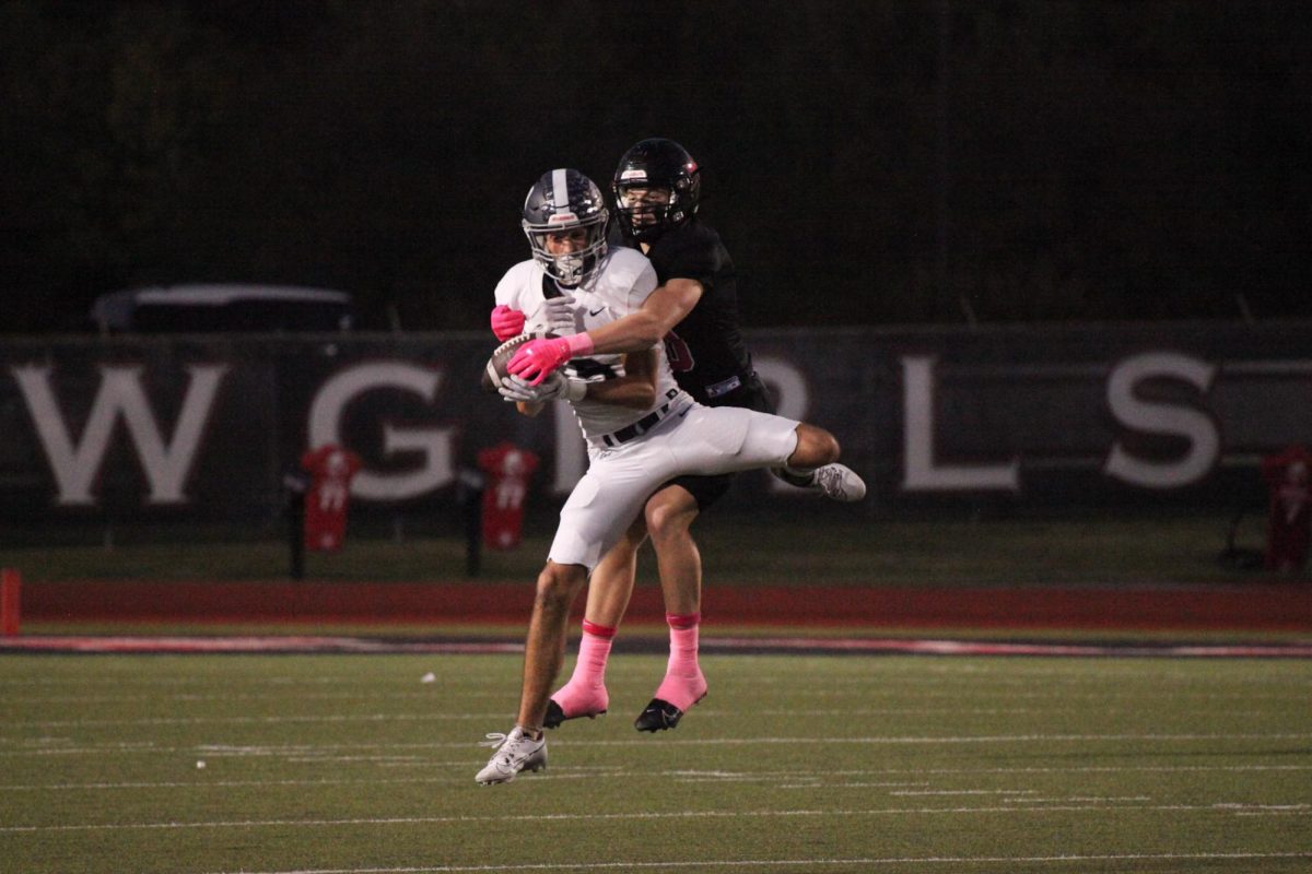 Coppell junior safety Alex Kraus tackles Flower Mound sophomore wide receiver Carter Massey on Oct. 27. The Cowboys defeated the Jaguars, 51-21, at Buddy Echols Field.