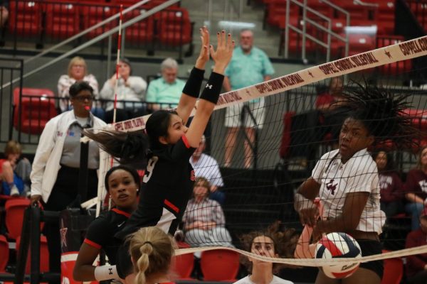 Coppell senior opposite hitter Alena Truong blocks against Plano on Tuesday at CHS Arena. The Cowgirls lost to the Wildcats, 11-25, 25-19, 22-25, 25-22, 15-7, for its last regular season match.