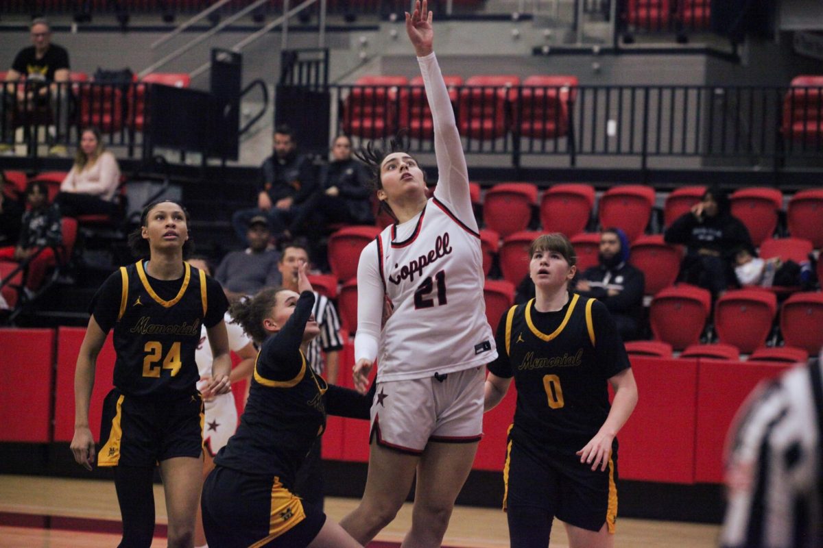 Coppell junior forward Sarah Mirza rebounds against Frisco Memorial at CHS Arena on Tuesday. The Cowgirls defeated the Warriors, 58-42. Kayla Nguyen