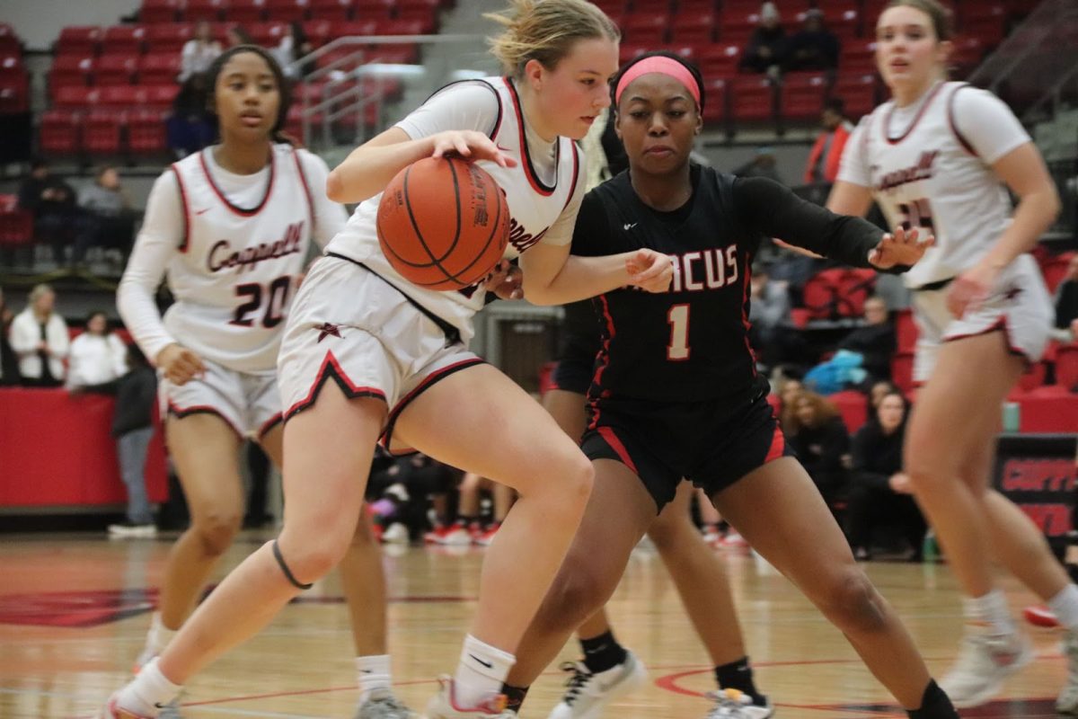 Marcus senior guard Kennedi Petteway guards Coppell junior shooting guard Landry Shearer as she drives. The Cowgirls defeated the Marauders, 59-45, on Friday at CHS Arena.