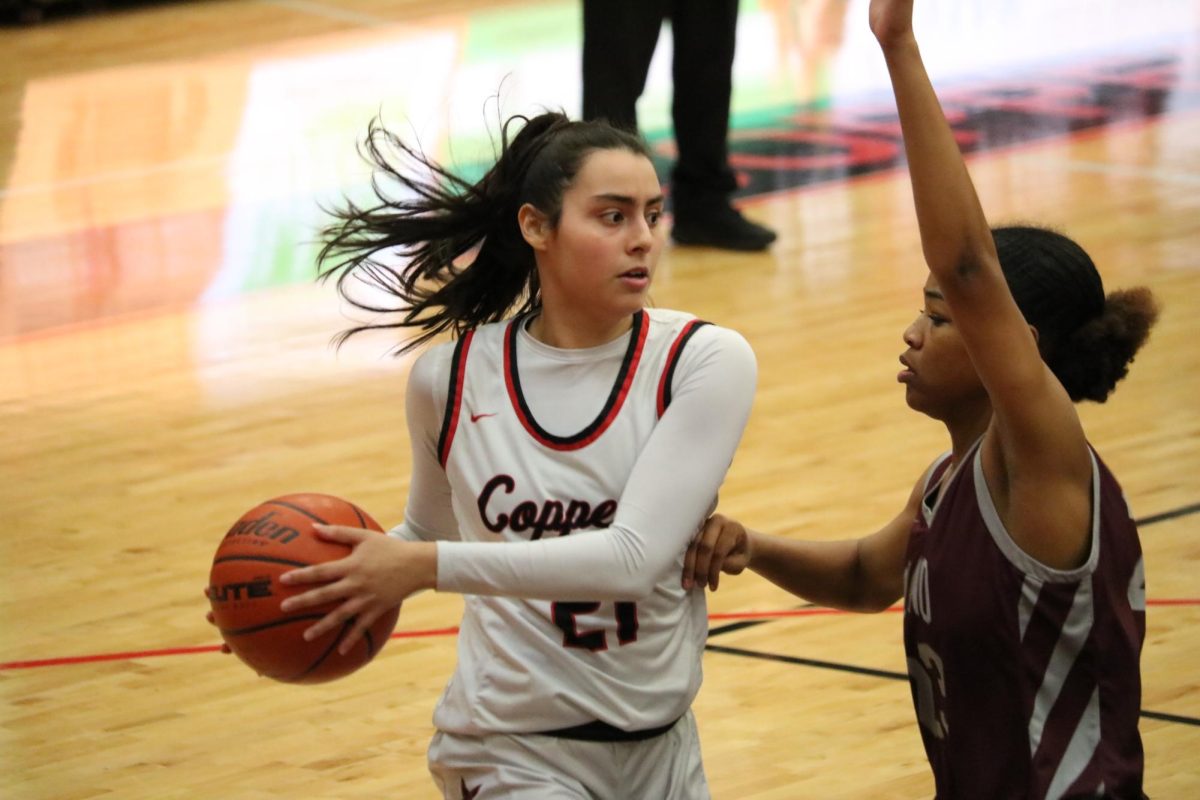 Coppell junior forward Sarah Mirza passes to Coppell senior guard Atia Medenica while Plano senior forward A’nysha Patrick defends at CHS Arena on Friday. The Cowgirls defeated the Wildcats, 71-38.
