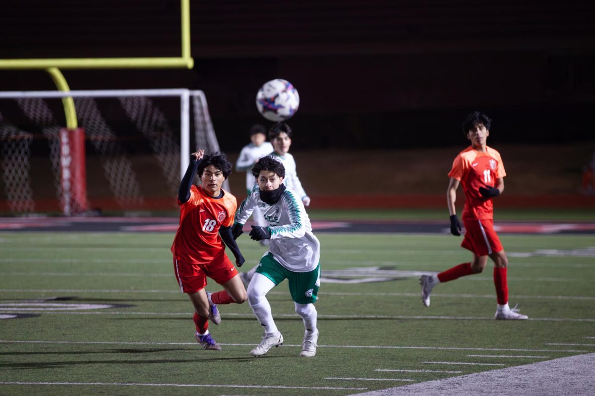 Coppell junior defender Chris Diaz and Azle senior midfielder Daniel Carlston both attempt to secure possession of the ball at Buddy Echols Field on Friday. Coppell won against Azle, 4-0. 