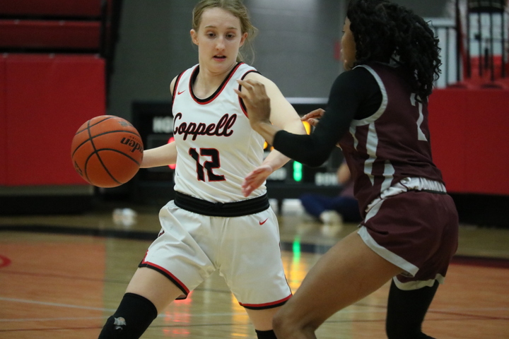 Coppell sophomore guard HC Harding drives against Plano junior shooting guard Kenya Palmer-Taylor on Friday at CHS Arena. Coppell defeated Plano, 71-38.