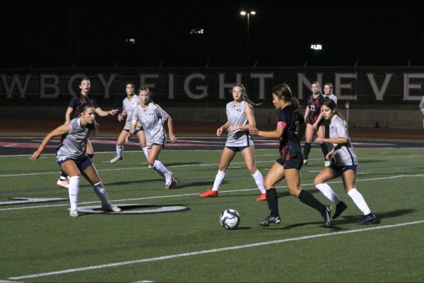 Flower Mound defends Coppell junior midfielder Summer Chen at Buddy Echols Field on Feb. 9. The Cowgirls host Flower Mound Marcus on Tuesday at 7:30 p.m. in their second meeting.