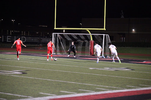 Coppell senior forward Nicholas Eppelman shoots against Plano senior goalkeeper Harrison McClain at Buddy Echols Field on Tuesday. The Cowboys defeated the Wildcats, 2-0. 