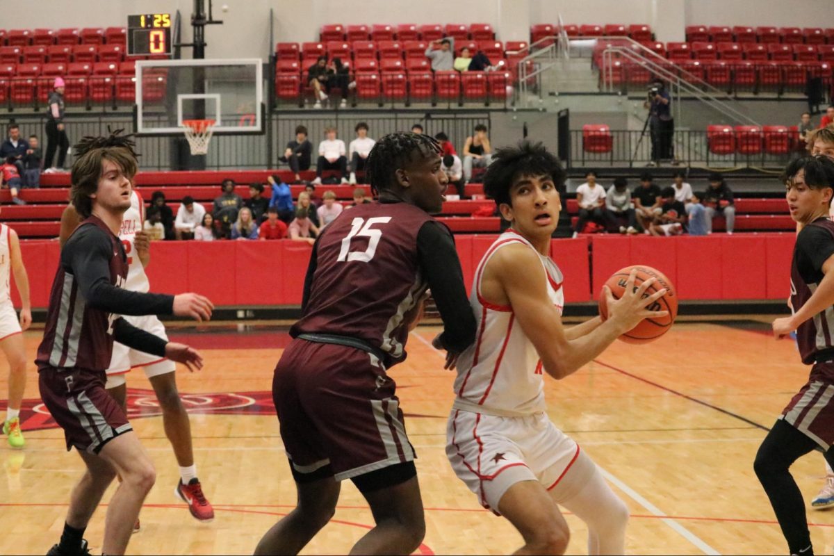 Coppell senior forward Arhan Lapsiwala shoots while being guarded by Plano sophomore Chris Hampton at CHS Arena on Tuesday. The Cowboys defeated the Wildcats, 64-62, on Senior Night.
