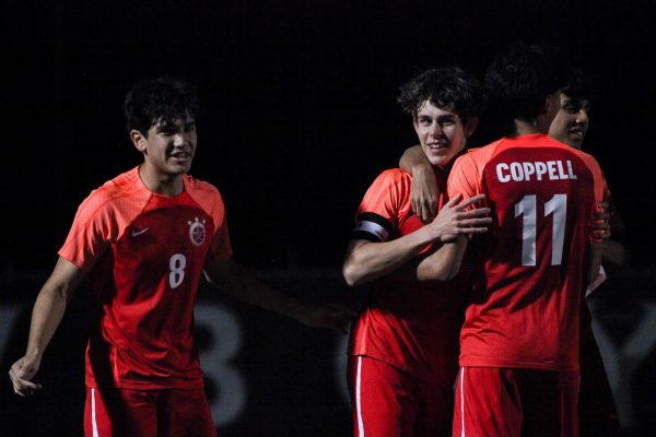 Coppell players celebrate after Coppell senior forward Samuel Stone scores its only goal in the game with 42 seconds left in the first half at Buddy Echols Field on Friday. Coppell defeated Lewisville, 1-0, tieing them with Hebron for second place in District 6-6A.