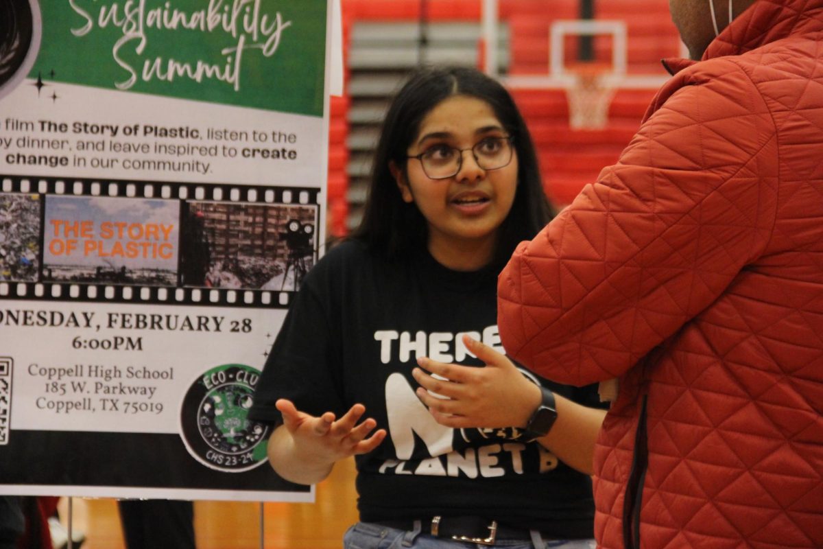 Coppell Eco Club Sierra Club liaison junior Ashia Agarwal shares information during the Spring Open House on Jan. 25 in the Large Gym. CHS clubs, organizations and courses set up booths in the Small and Large Commons, as well as the Large Gym, to represent their programs.