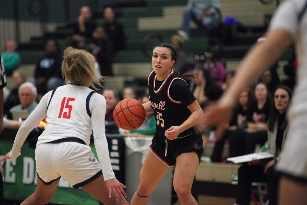 Coppell senior guard Atia Medenica looks for an open teammate while being guarded by Allen sophomore guard Simone Richmond at Lake Dallas High School on Monday. The Cowgirls fell to the Eagles, 55-49, in the Class 6A Region I bi-district playoffs.