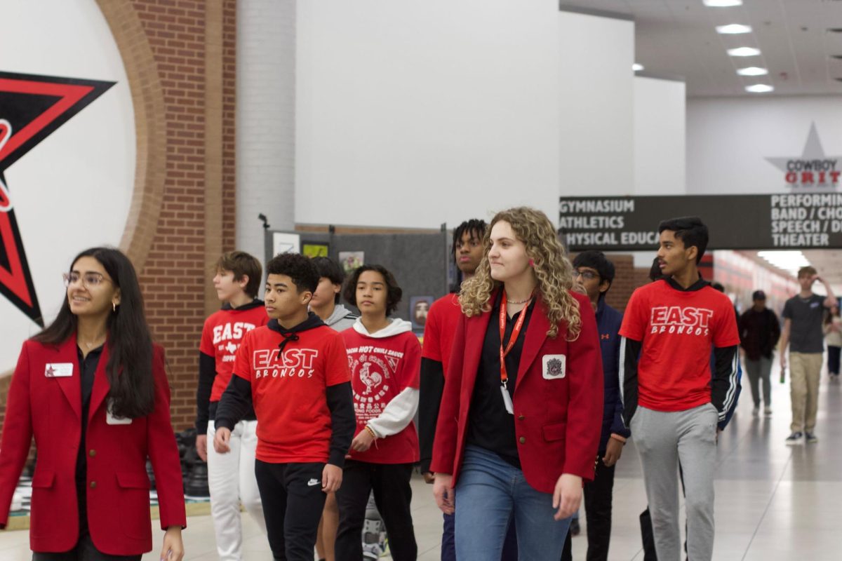 Coppell High School  Red Jacket Chloe Kryzak guides rising freshmen from Coppell Middle School East around campus for Shadow Day on Jan. 23. Eighth grade students toured CHS9, New Tech High @ Coppell and Coppell High School.