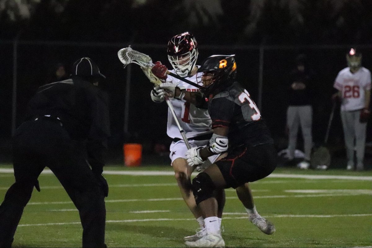 Coppell sophomore midfield Duncan Ross and Rockwall senior midfield Ricci Ankton fight for possession at Lesley field on Feb. 16. The Cowboys play St. John’s School on Saturday at 1 p.m. at Lesley Field. 
