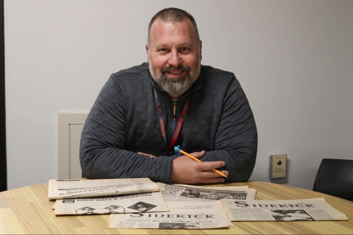 Coppell High School English III teacher Sean Smith keeps a collection of old issues of The Sidekick from when he served as The Sidekick entertainment editor from 1994-96. Smith attended CHS from 1992-96 and his love of words and writing brought him back to CHS as a teacher. 