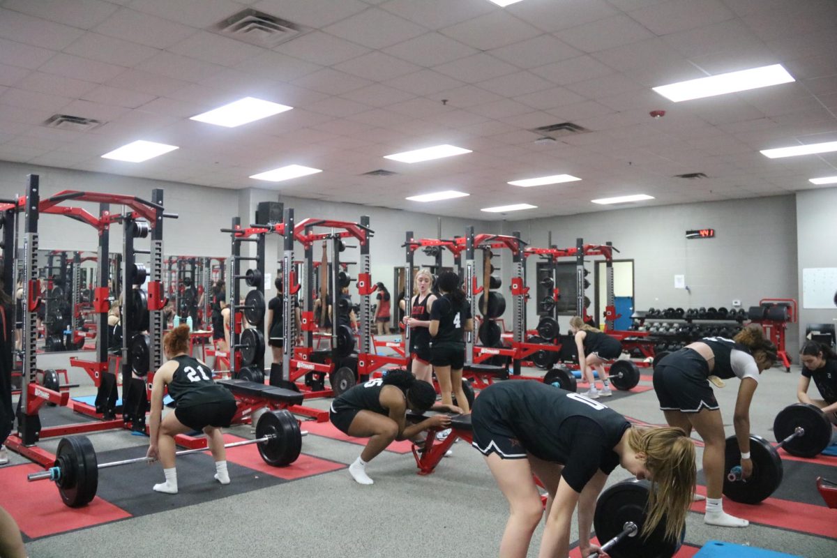 Coppell girls basketball team works out in the CHS weight room on Wednesday. A new workout program had been established for the Coppell girls basketball team to improve strength and stamina.
