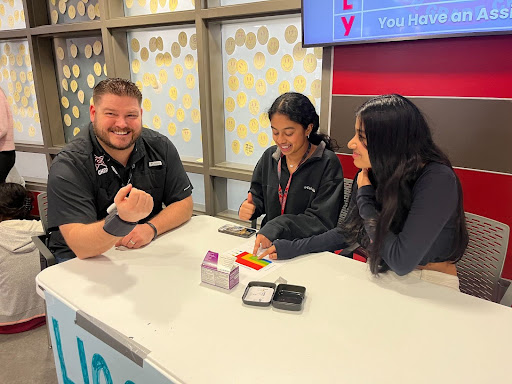 CHS9 Principal Cody Koontz gets his blood pressure taken by freshmen HOSA members in the cafeteria during lunch on Tuesday. In honor of American Heart Health Month, HOSA members measured blood pressure to spread awareness about heart and blood health.