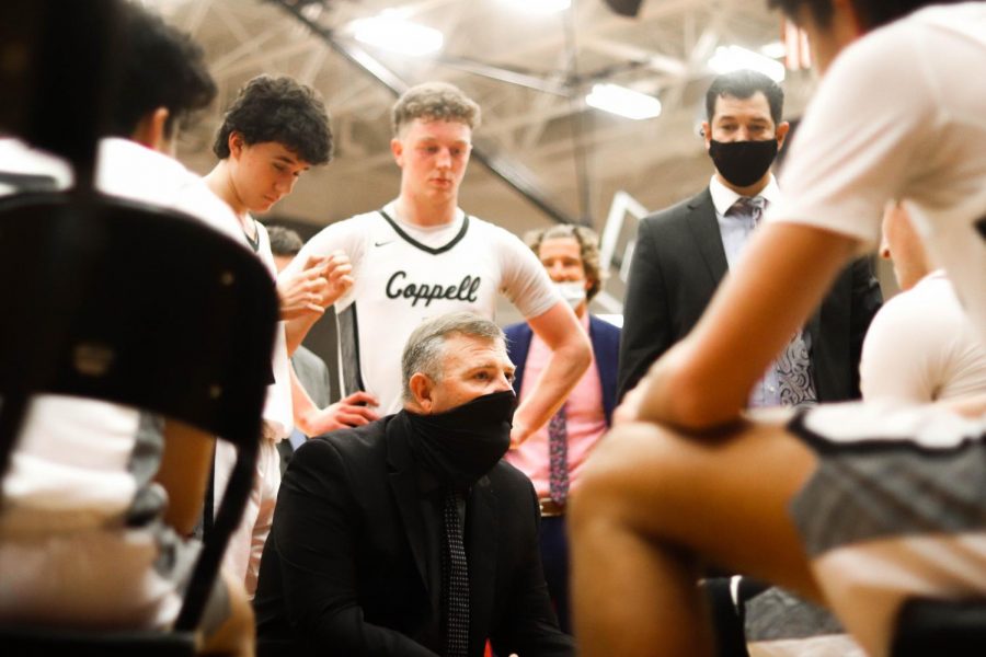 Coppell+coach+Clint+Schnell+discusses+a+game+plan+with+the+Cowboys+prior+to+overtime+against+Lewisville+on+2021+in+the+CHS+Arena.+Schnell+resigned+as+the+head+coach+for+boys+basketball+yesterday+after+six+years.
