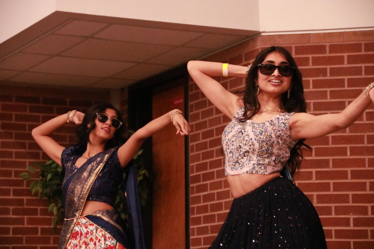 Coppell High School juniors Shreya Panyam and Varshini Byreddy dance to a medley of Bollywood music in the CHS Commons. The Junior World Affairs Council (JWAC) hosted Heritage Night on Friday allowing students to display their cultures in various art forms.