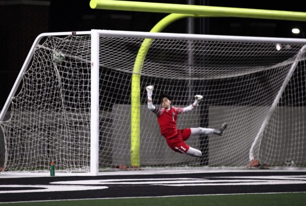 Coppell senior goalkeeper Jacob Campbell misses a save on a free kick by Prosper senior forward Caden Berg at Prosper Children’s Health Stadium on Tuesday. The Eagles defeated the Cowboys, 2-0, in the Class 6A Region I bi-district playoffs.