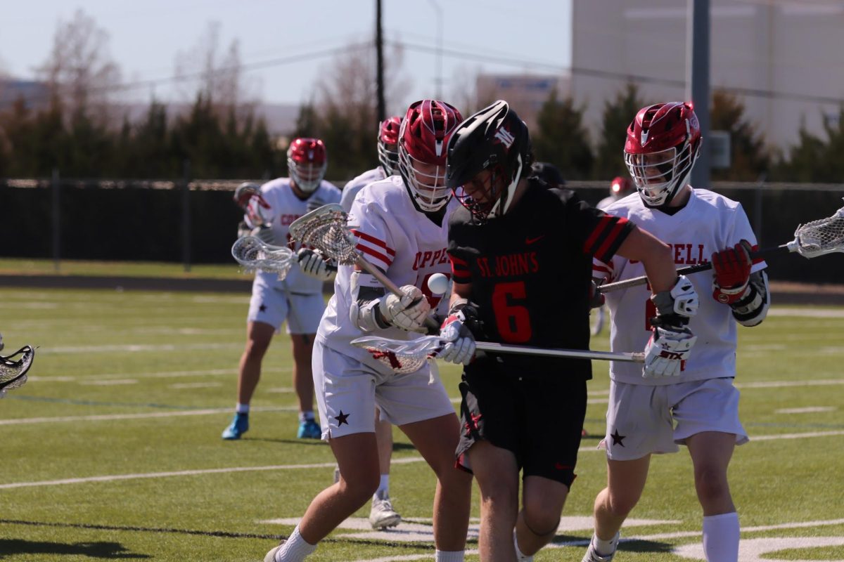 Houston St. John’s senior Brooks Danile fights for possession against Coppell senior attack Chase Waddill and junior attack Cale Stricklin on Saturday at Lesley Field. The Mavericks defeated the Cowboys, 7-5.