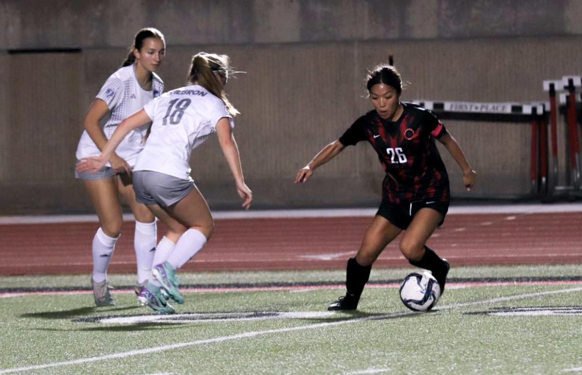 Hebron+senior+midfielder+Jacey+Beer+defends+Coppell+junior+midfielder+Summer+Chen+at+Buddy+Echols+Field+on+March+6.+The+Cowgirls+host+Plano+in+their+final+match+of+the+regular+season+at+Buddy+Echols+Field+tonight+at+7%3A30+p.m.
