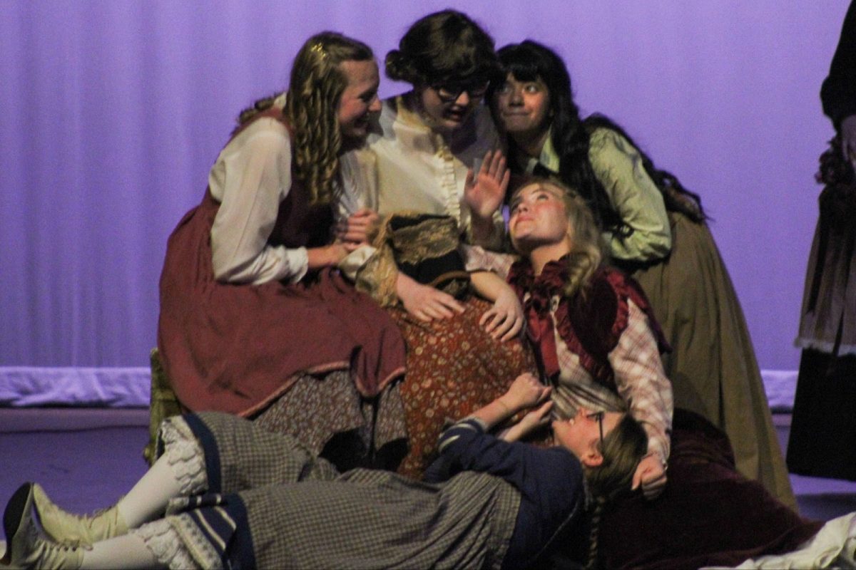 Coppell High School senior Elise Howe as Marmie March, New Tech @ Coppell High Lucy Martinson as Beth, CHS junior as Sanjana Sreemushta as Jo, senior Olivia Willey as Meg kneeling besides Marmie and New Tech @ Coppell High junior Ellie Reese as Amy on the ground in the CHS Auditorium on March 8. The Cowboy Theatre Company production of “Little Women goes through the lives of the four March sisters during the Civil War as they transition from girlhood to womanhood. 
