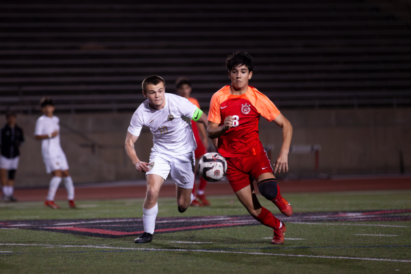Coppell senior midfielder Anson Skorka and Plano East senior midfielder Duncan Sullivan rush to gain possession at Buddy Echols Field on Friday. The Cowboys tied the Panthers, 0-0.