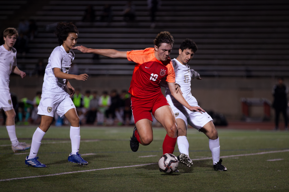 Coppell junior forward J McGill and Plano East junior forward Mark Khoury fight for possession at Buddy Echols Field on Friday. The match concluded in a 0-0 tie. 