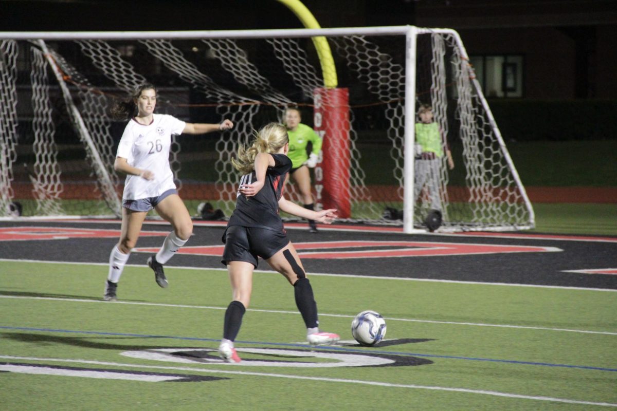 Plano+junior+midfielder+Alycia+Piesker+defends+Coppell+senior+defender+Lauren+Monroe+at+Buddy+Echols+Field.+The+Cowgirls+defeated+the+Wildcats%2C+7-0%2C+on+Tuesday.+