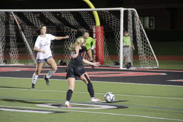 Plano junior midfielder Alycia Piesker defends Coppell senior defender Lauren Monroe at Buddy Echols Field. The Cowgirls defeated the Wildcats, 7-0, on Tuesday. 