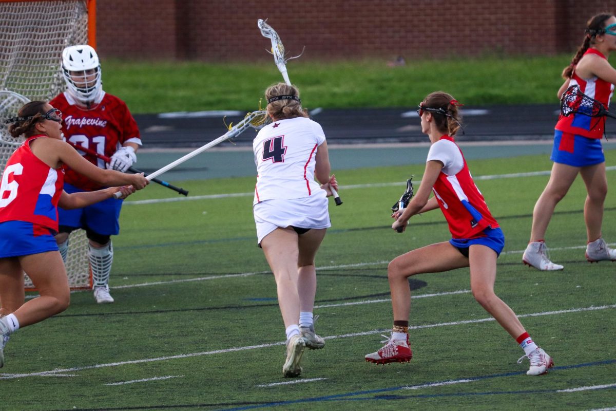 Coppell senior attacker Kate Nelson scores in the first quarter against Grapevine on Friday at Coppell Middle School North. Coppell defeated Grapevine, 9-3, in its final home game of the season. 
