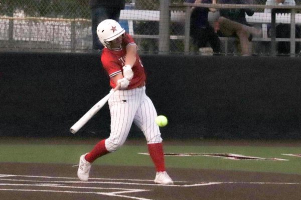 Coppell shortstop Mallory Moore hits a single at Coppell ISD Baseball/Softball Complex on Friday. Plano West  defeated the Cowgirls, 8-1.